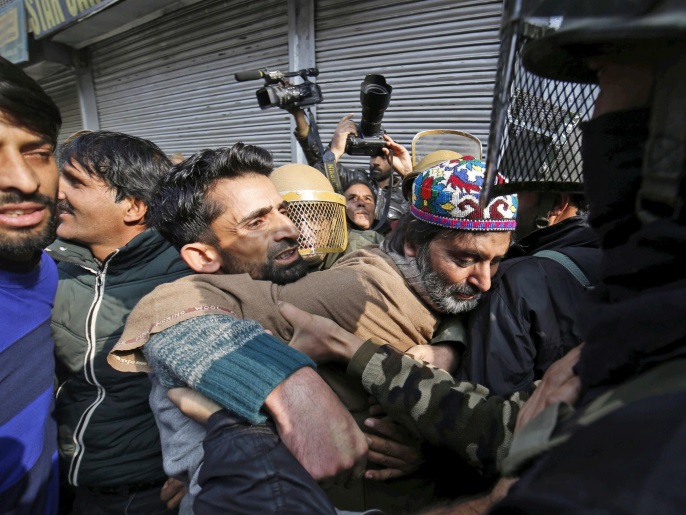 Indian Police detains the chairman of the Jammu Kashmir Liberation Front (JKLF), Muhammad Yasin Malik (C) as he tried to march after Friday prayers in Srinagar, the summer capital of Indian Kashmir, 02 December 2016. Police used dozens of tear smoke shells to disperse Kashmiri Muslim protestors.