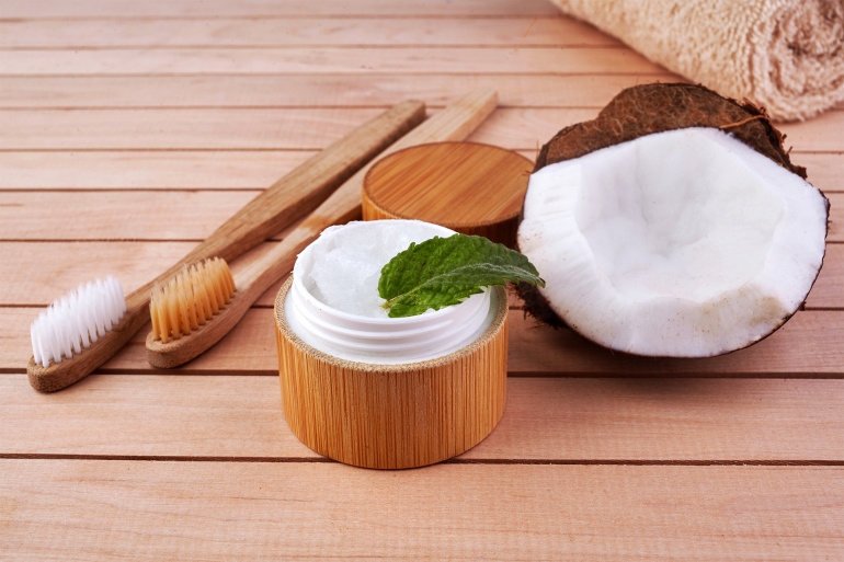 Coconut oil and mint homemade toothpaste, eco friendly bamboo toothbrush, natural healthcare. shutterstock_1457273816